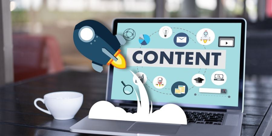 Laptop with rocket graphics and content marketing ideas on screen.